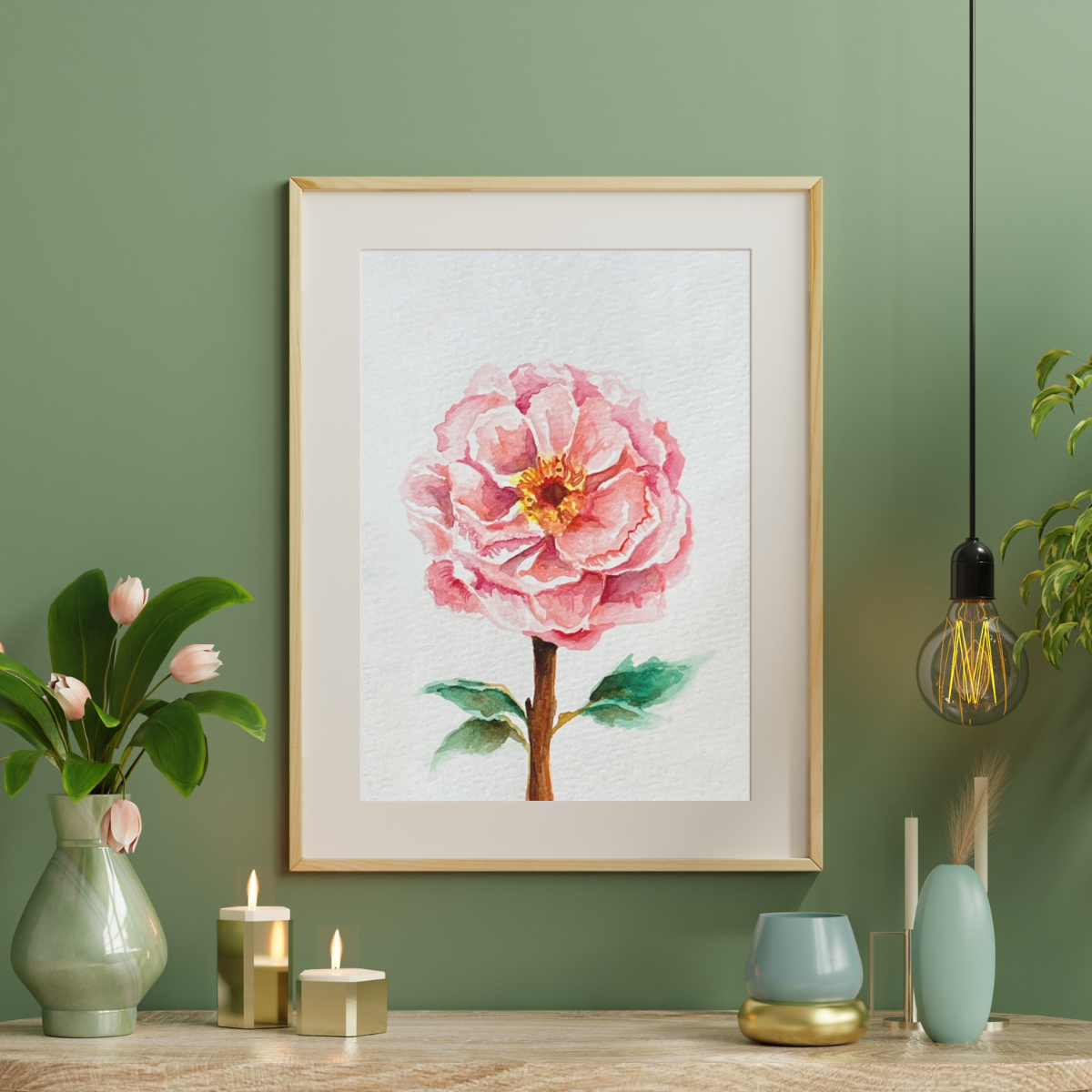 Framed artwork of a pink flower on a green wall with decorative items.