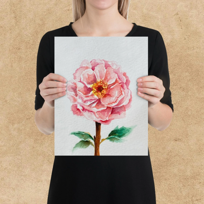 Person holding a painting of a pink flower against a beige background
